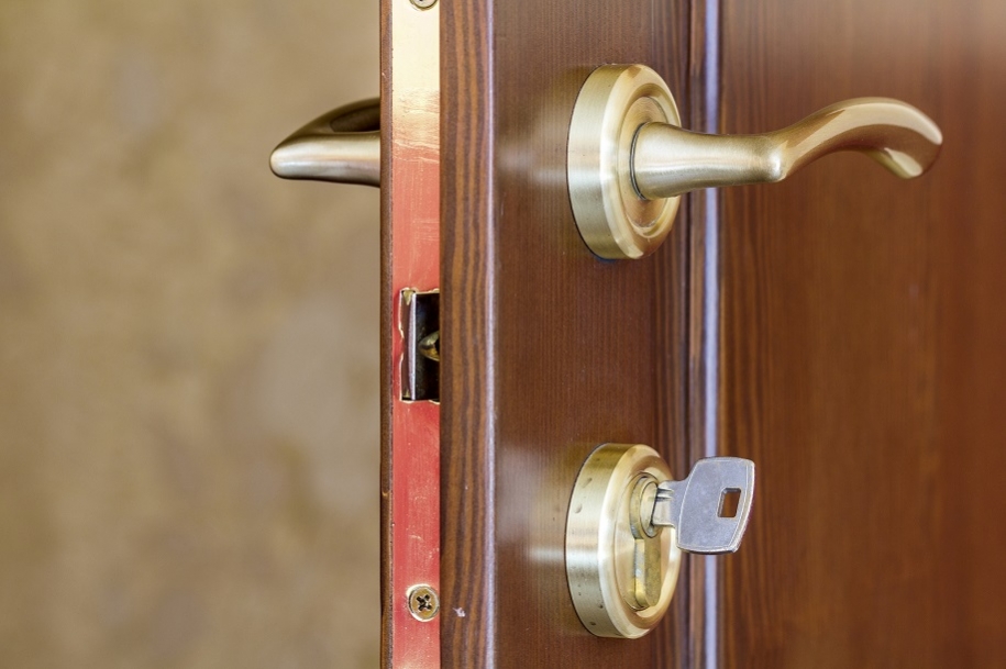 Key in front door of a house.