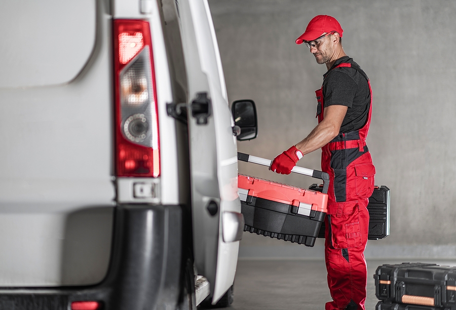 man loads van with tools